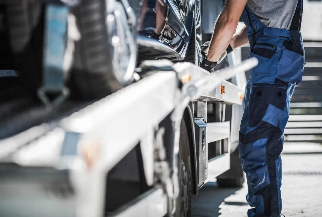 Saskatoon tow truck driver loading a car onto a flatbed
